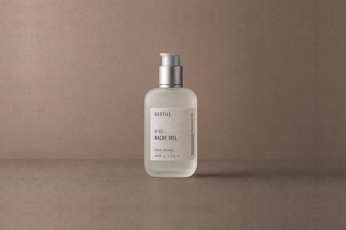Nacre Veil — Facial Essence by DESTILL on a dusty mineral clay background