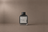 Cold Cinder — Extrait de Parfum by DESTILL on a dusty mineral clay background