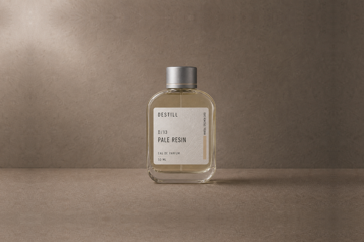 Pale Resin — Eau de Parfum by DESTILL on a dusty mineral clay background