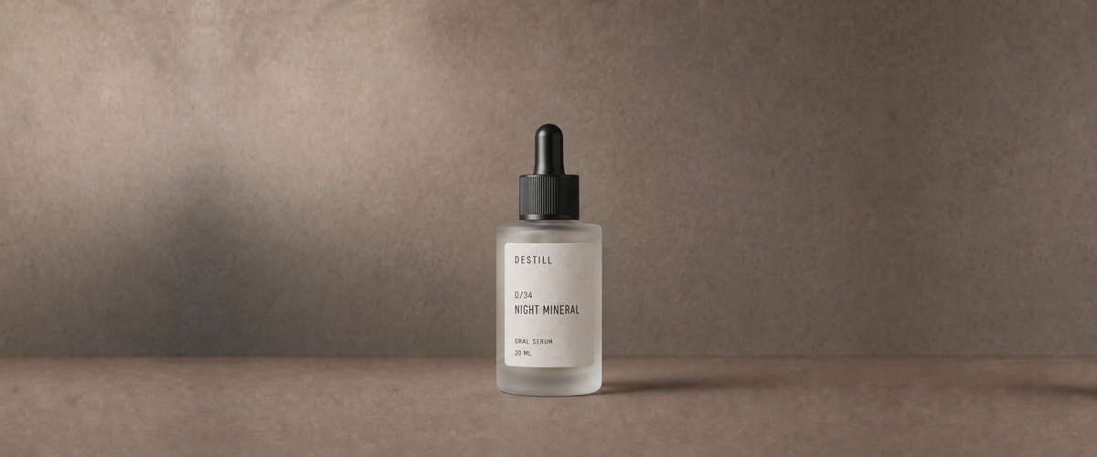 Night Mineral oral serum by DESTILL on a warm mineral clay background