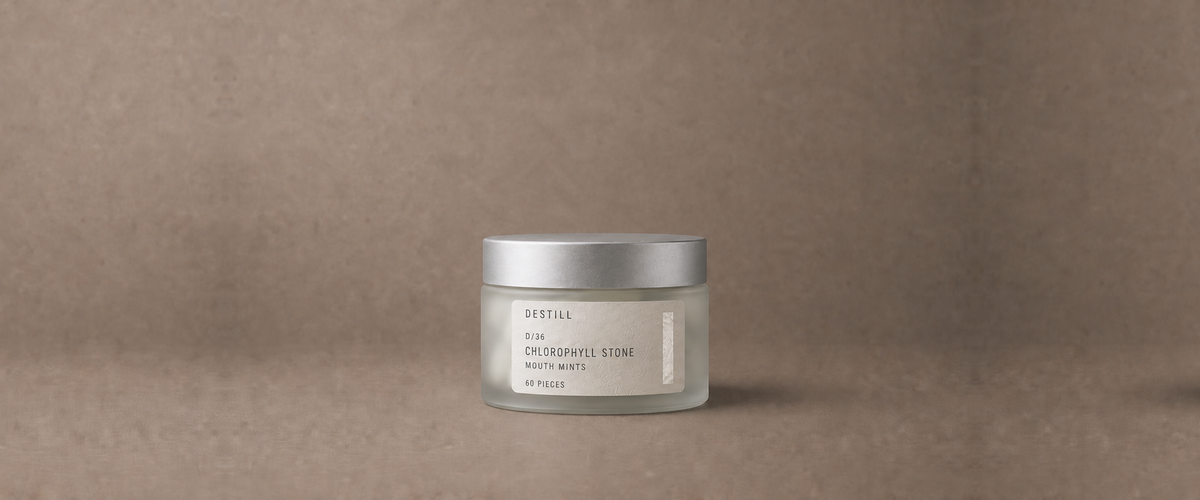 Chlorophyll Stone mouth mints by DESTILL on a warm mineral clay background